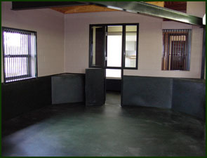 Room with black flooring and black siding on the walls.